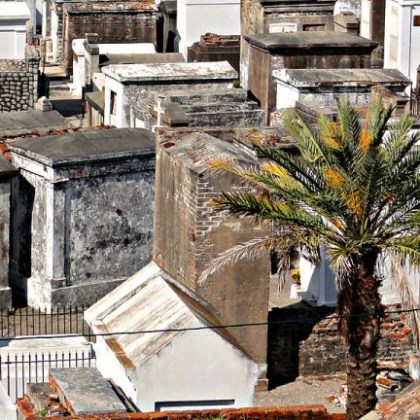 a person sitting at a table in front of a building