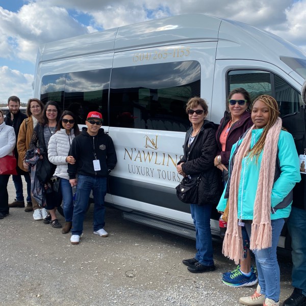 a group of people standing in front of a crowd posing for the camera