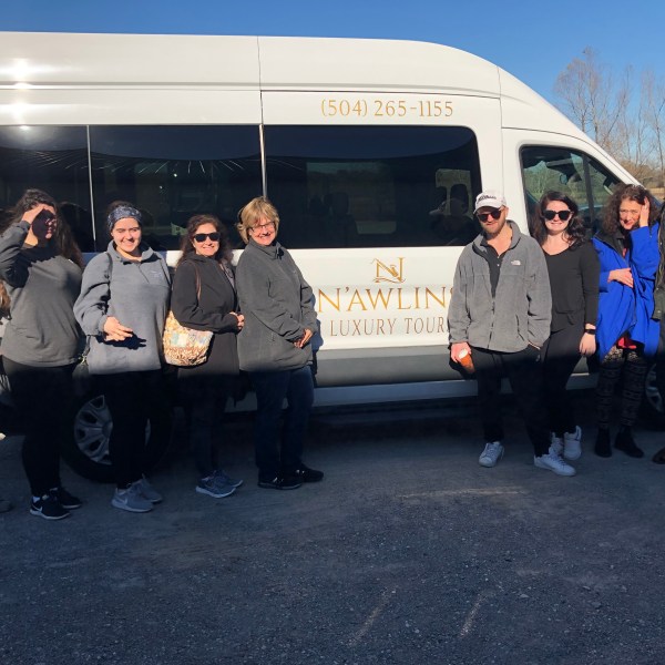 a group of people standing in front of a bus