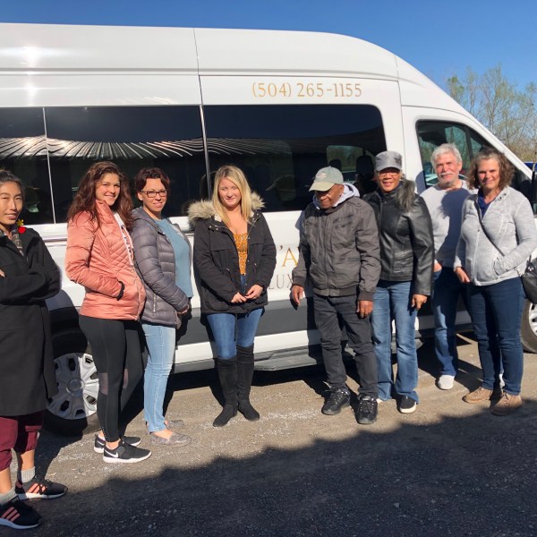 a group of people standing in front of a bus