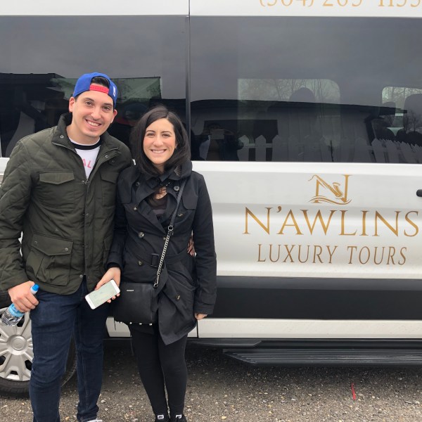 a person standing in front of a car posing for the camera