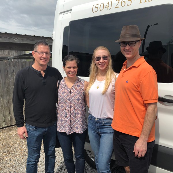 a person standing in front of a group of people posing for the camera