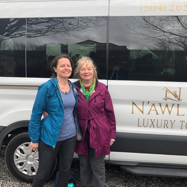 a person standing in front of a car posing for the camera