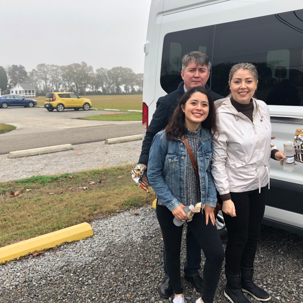 a person standing in front of a bus